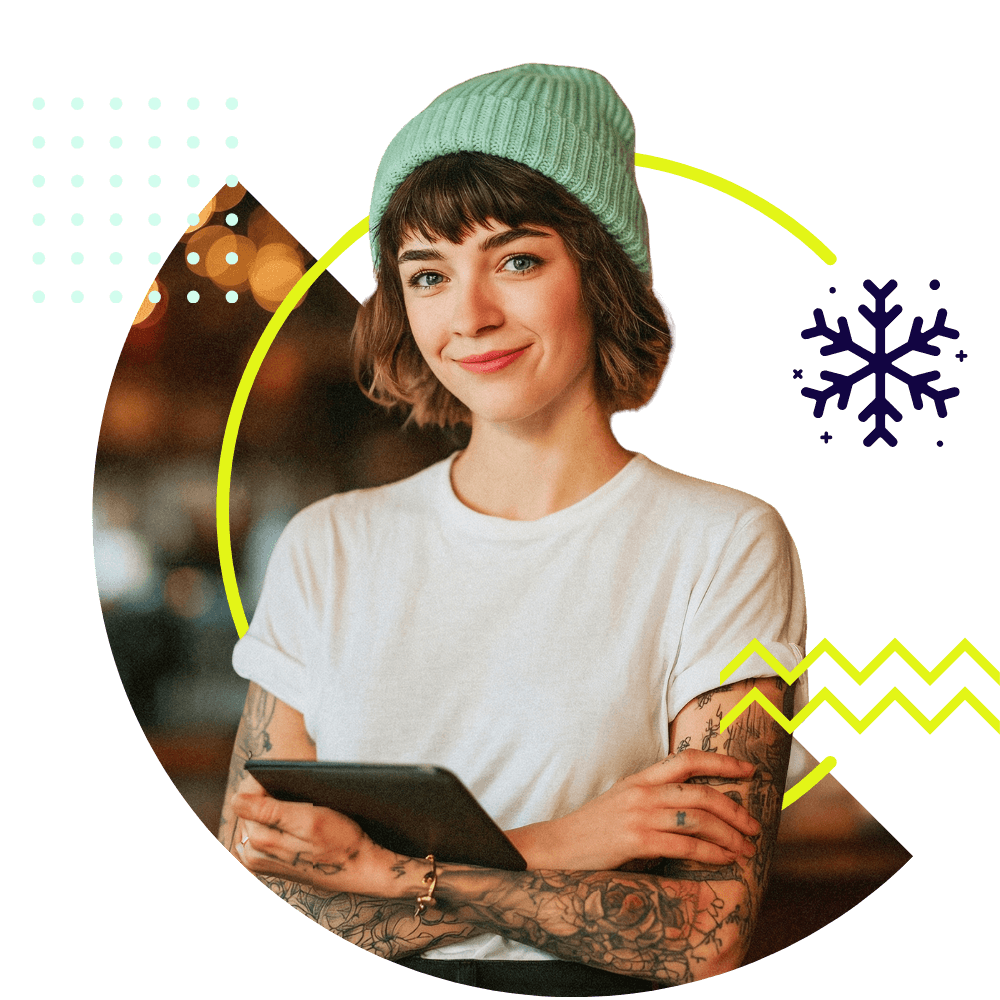 Frau mit Tablet und winterlicher Mütze schaut in die Kamera